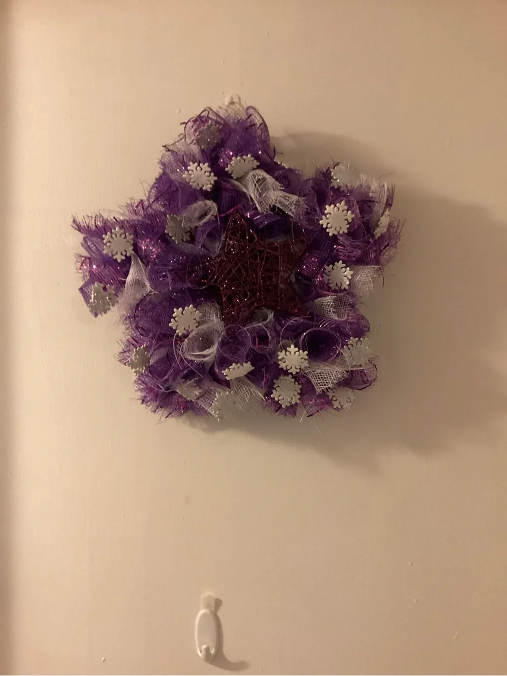 Purple star wreath with snowflakes, approximately 13 inches